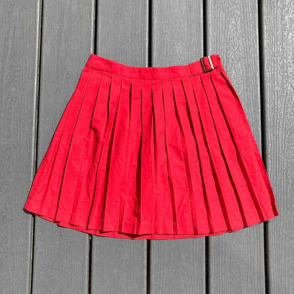 Cherry red pleated mini skirt with belt buckle detail, preppy indie sleaze